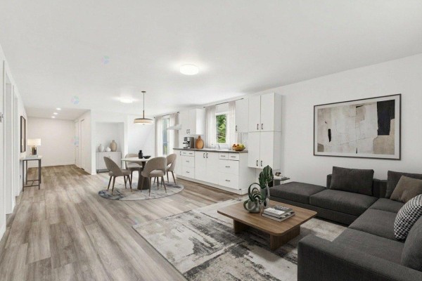 Bright kitchen area with white cabinetry and large windows overlooking greenery - 17 Rue Blais, Val Des Monts