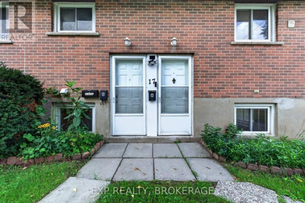 Close-up of two white front doors at 17 Shaw Street with adjacent windows. - 17 Shaw Street, Kingston