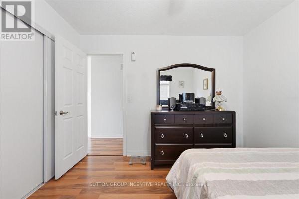 Bedroom with dresser, mirror, closet and striped bedding - 17 White Crescent Barrie