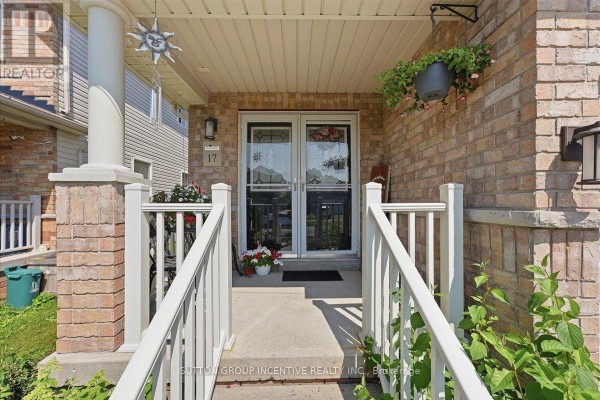Front porch entrance with brick pillars, white railings, and double glass doors at 17 White Crescent. - 17 White Crescent, Barrie