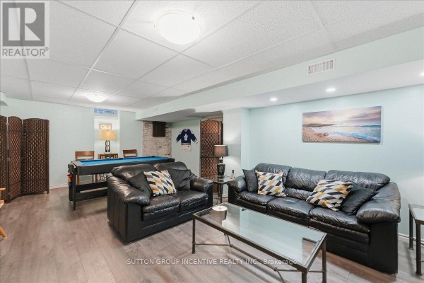 Finished basement living room with pool table and leather sofas - 17 White Crescent Barrie
