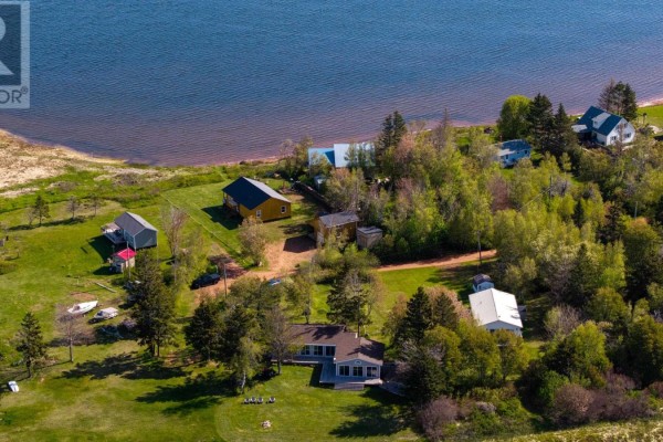 Cozy den with leather recliners, built-in shelves, and wood-paneled walls. - 170 Courts Island Road, Donaldston
