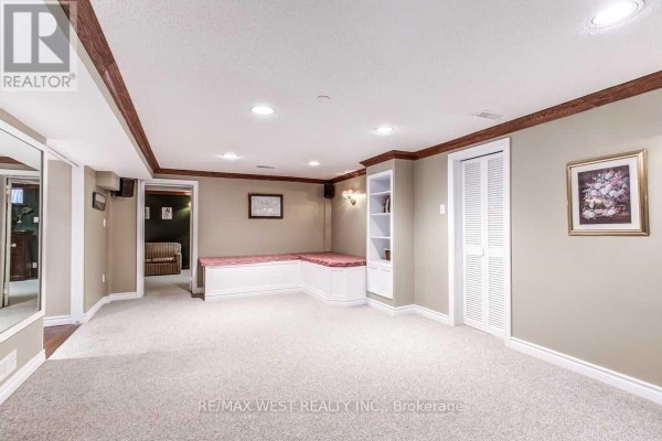 Finished basement with built-in bench seating and shelving - 170 Newton Drive Toronto