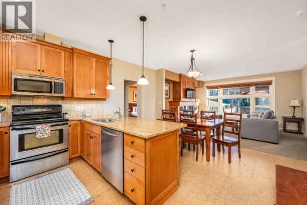 Kitchen with wood cabinets, granite counters, stainless steel appliances, and dining area. - 170 Silver Lode Lane Lane Unit# 304, Silver Star