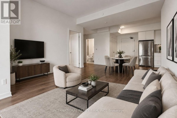 Empty bedroom with hardwood floors, white walls, and a sliding glass door. - 1701 - 1606 Charles Street, Whitby