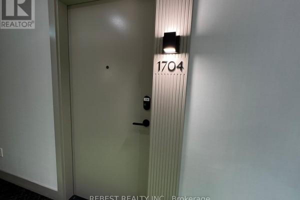 Apartment entrance door 1704 with modern lighting fixture and keyless entry system. - 1704 - 209 Steeles Avenue W, Brampton