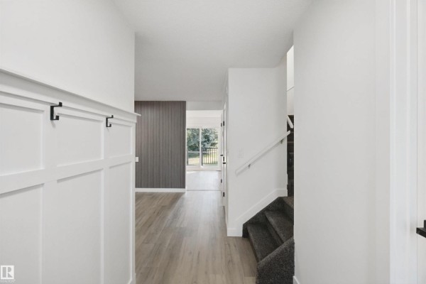 Interior view of entryway, showing hallway, staircase, and doorway to living area. - 17041 100 St Nw, Edmonton