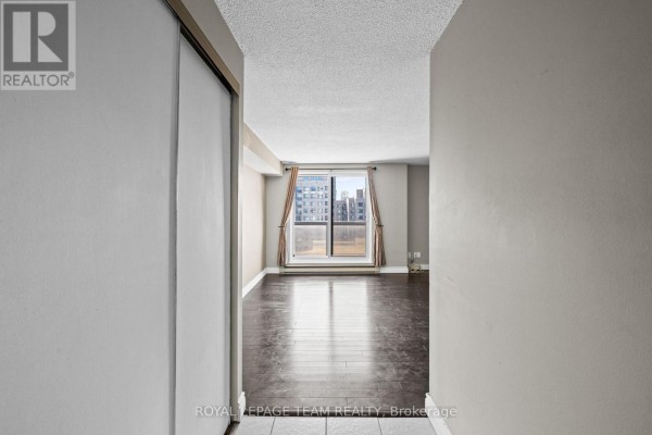 View from inside the apartment looking into the living area and out the balcony doors. - 1705 - 199 Kent Street, Ottawa