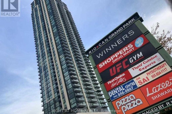 Low angle view of a tall residential building with a prominent RIO CAN GRAND PARK sign. - 1705 - 3975 Grand Park Drive, Mississauga
