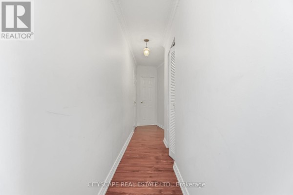 Hallway with white walls, hardwood floors, and doors at the end. - 1706 - 20 Mississauga Valley Boulevard, Mississauga