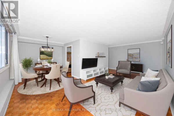 Hallway view of a living room with a leather chair and a dining area. - 1706 - 2625 Regina Street, Ottawa