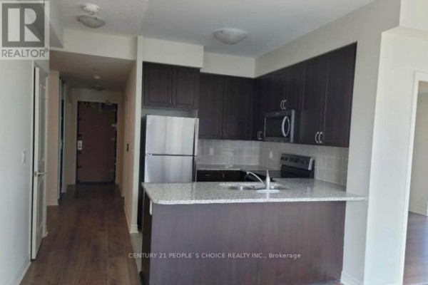 Kitchen with dark brown cabinetry, stainless steel appliances, granite countertops, and a breakfast bar. - 1706 - 349 Rathburn Road W, Mississauga