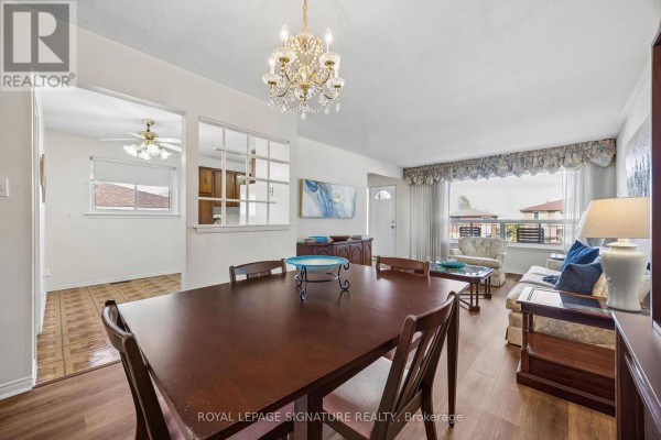 Renovated open-concept living and dining area with light wood floors and large windows. - 171 Petworth Crescent, Toronto