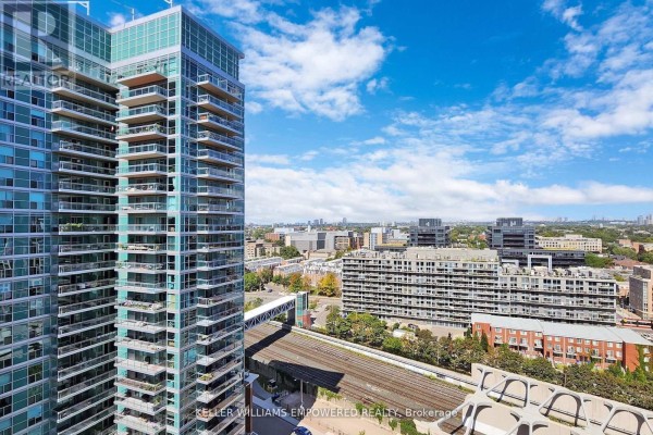 Aerial view of the condo building and surrounding cityscape with train tracks visible. - 1711 - 50 Lynn Williams Street, Toronto
