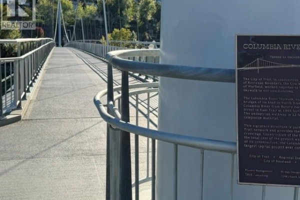 Close-up of a pedestrian bridge over the Columbia River with a historical plaque. - 1717 Columbia Avenue, Trail