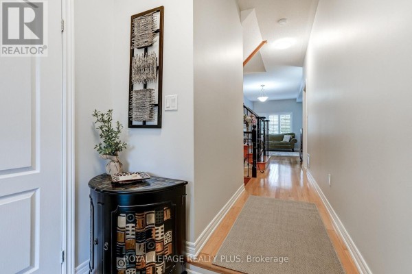 Interior view of a hallway with light grey walls and hardwood floors. - 172 Lauderdale Drive, Vaughan
