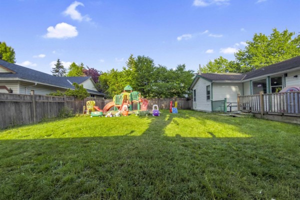 View of the backyard and playground from a distance on a clear day. - 17209 62a Avenue, Surrey