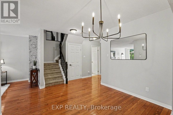 Interior view showing a dining area, staircase with carpeted steps, and doorways to other rooms. - 173 Beatrice Drive, Ottawa