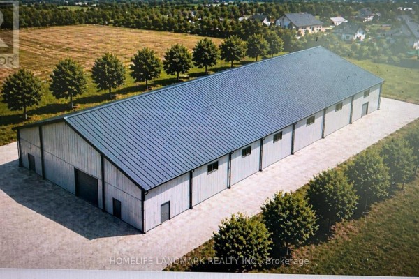 Exterior of a long, silver metal barn with a grey roof on a paved lot. - 17305 10th  Concession, King