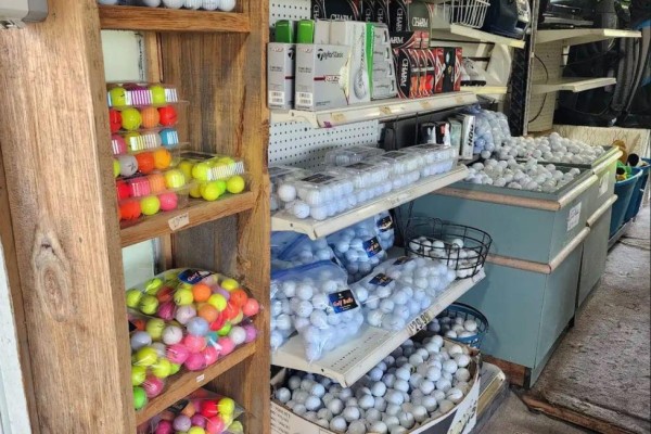 Interior shelving unit filled with various colored golf balls and retail displays. - 1732 Merrittville Highway, Thorold