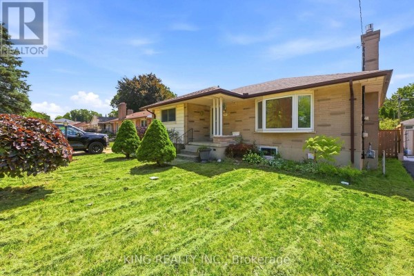 Side view of a single-story brick house with a bay window and a well-maintained lawn. - 1737 Wavell Street, London East