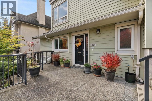 Front entrance of a townhouse with potted plants on the porch. - 1741 Chesterfield Avenue, North Vancouver