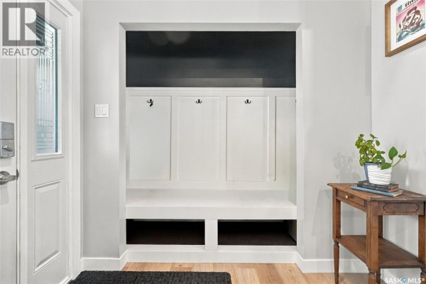 Built-in white bench with cubbies and hooks in a home entryway. - 1743 Blair Bay E, Regina