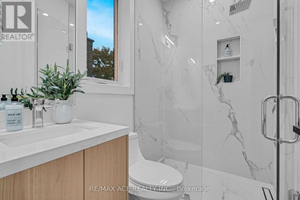 Modern bathroom with vanity, walk-in shower, and marble-look tiles - 175 Harewood Avenue Toronto