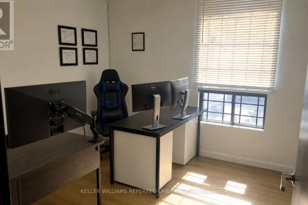 Office space with a desk, three monitors, a gaming chair, and certificates on the wall. - 175 Limestone Crescent, Toronto