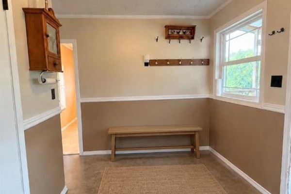 Mudroom with a wooden bench, coat rack, and a small wooden cabinet on the wall. - 17530 Township Road 763a, Rural Big Lakes County