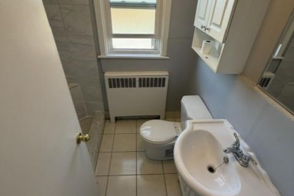 Full bathroom view showing toilet, sink, vanity, and mirrored cabinet. - 1759 King Street E Unit# 32, Hamilton