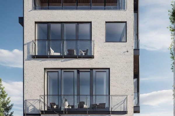 Multi-story building exterior with white brick facade and balconies with glass railings. - 175b Lake Shore Drive, Toronto