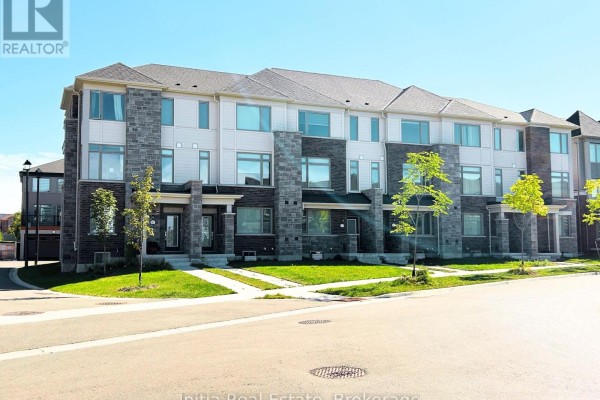 Exterior view of modern townhouses with stone and siding facade, green lawn in front. - 176 Lageer Drive, Whitchurch Stouffville