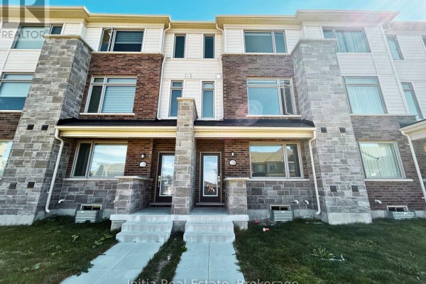 Close-up of two townhouse entrances with stone pillars, white siding, and windows. - 176 Lageer Drive, Whitchurch Stouffville