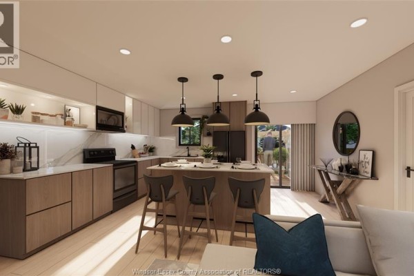 Kitchen island with bar stools and view through sliding glass doors to an outdoor patio. - 176 Ross Crescent, Colchester