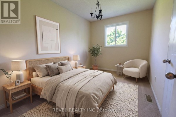 Bedroom with rattan headboard bed, armchair, and artwork - 176 Towerhill Road Peterborough
