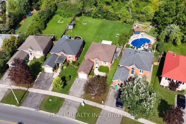 Aerial view of houses with pools and green yards - 176 Towerhill Road Peterborough