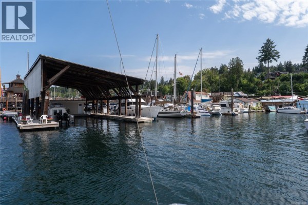 Covered dry boat storage structure on the waterfront with docked boats. - 1765 Cowichan Bay Rd, Duncan
