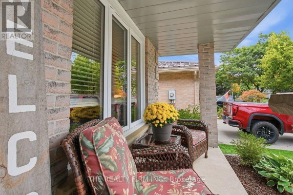 Wicker chair on the front porch with a red truck visible in the background. - 177 Bournemouth Drive, London East