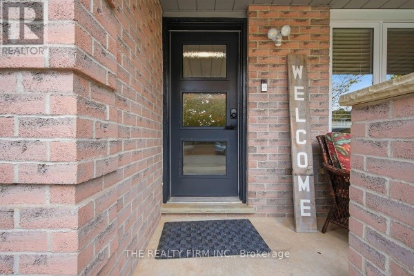 Front door with three glass panels and a welcome sign next to it. - 177 Bournemouth Drive, London East