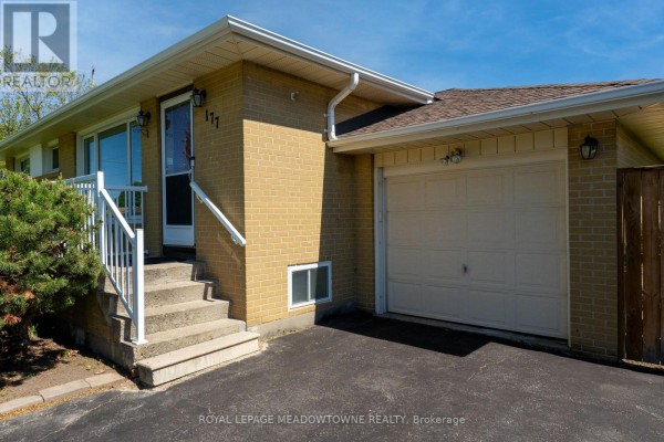 Exterior view of the house showing the front entrance, concrete stairs, and attached garage. - 177 Delrex Boulevard, Halton Hills