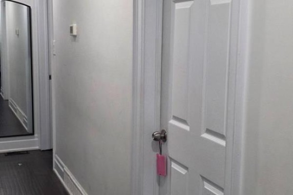 Hallway with white doors, gray walls, and dark wood flooring. - 1770 Altona Road, Pickering