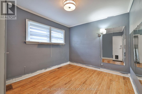 Bedroom with king-size bed, two nightstands, a dresser, and wall mirrors. - 178 Angelene Street, Mississauga