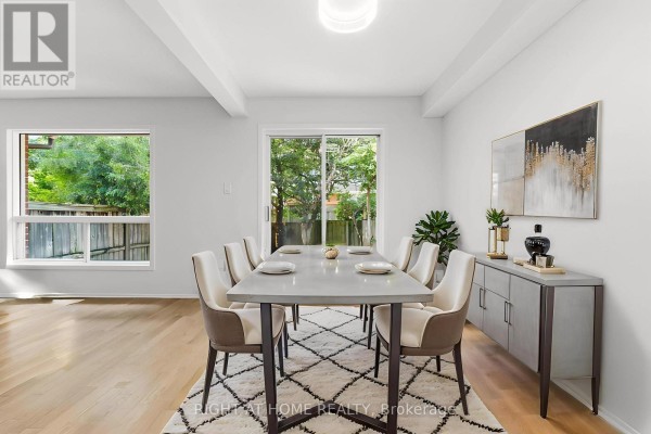 Dining room with a table set for eight, sideboard, and patio doors. - 178 Presland Road, Ottawa