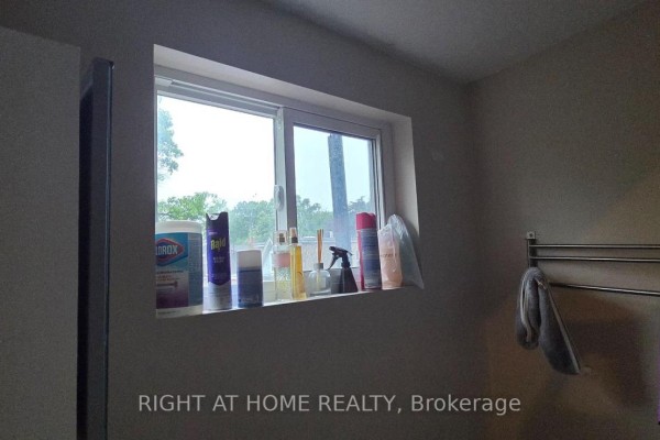 Window sill in a bathroom with toiletries and a towel rack on the wall. - 179 Gilmour Avenue, Toronto