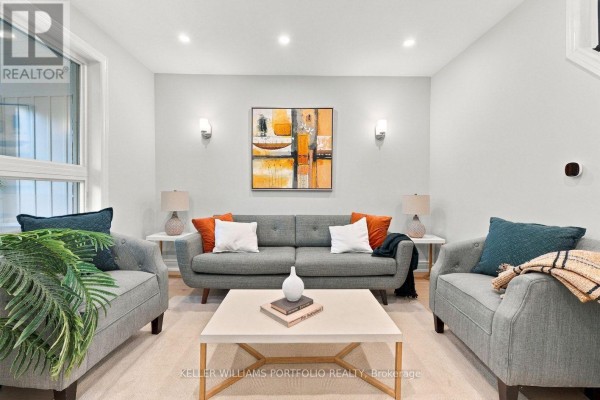 Living room with grey sofa, two accent chairs, and a coffee table. - 179 Oakcrest Avenue, Toronto