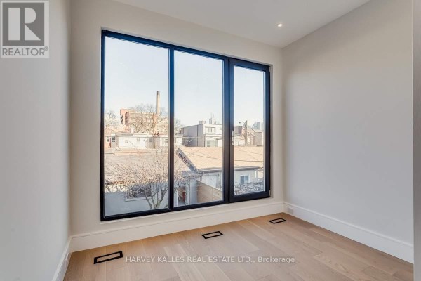 Interior room with large window and hardwood floors - 179 Palmerston Avenue Toronto