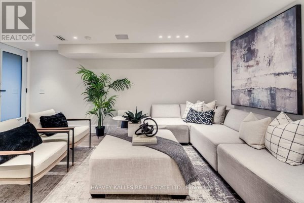 Modern living room with sectional sofa and abstract art - 179 Palmerston Avenue Toronto