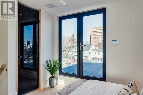 Modern living room with large windows and city view - 179 Palmerston Avenue Toronto