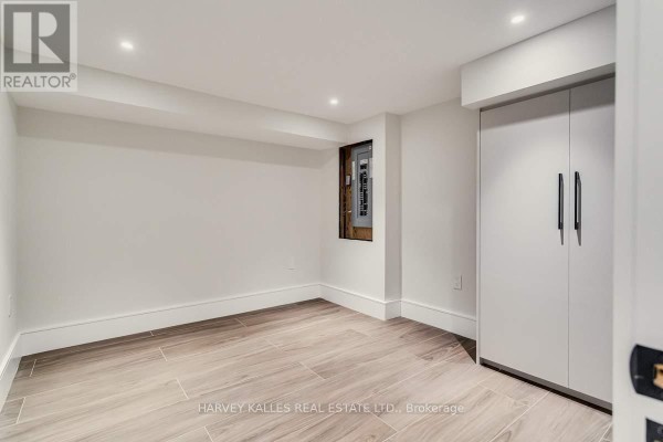 Modern basement room with built-in storage and tile floors - 179 Palmerston Avenue Toronto
